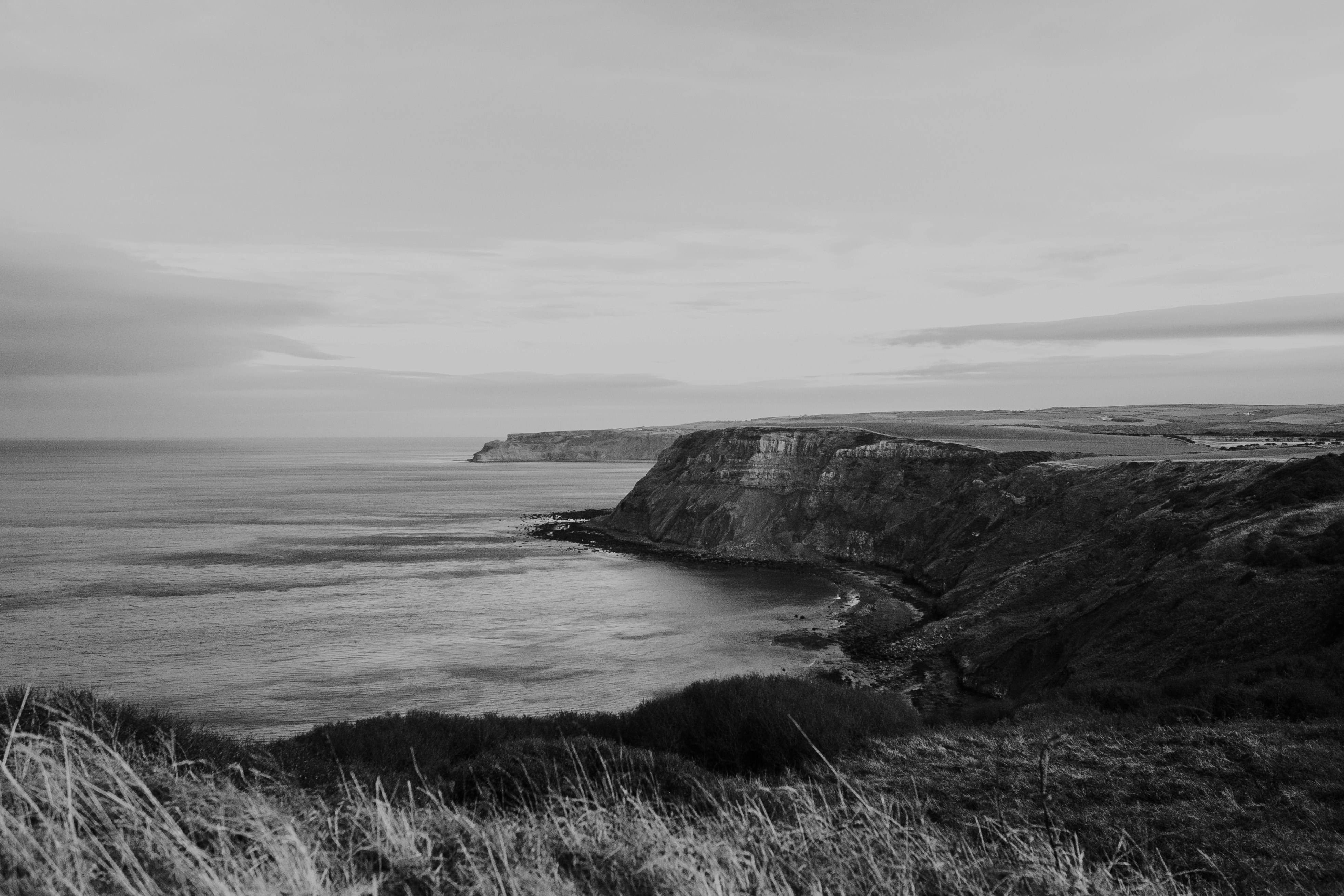 grayscale photography of cliff